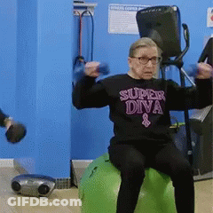 An Elderly Woman Wearing A Super Diva Shirt Is Sitting On A Green Exercise Ball GIF