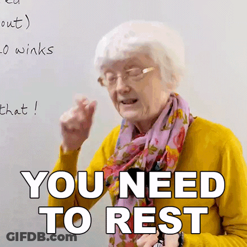 An Elderly Woman Wearing A Yellow Sweater And A Pink Scarf Says You Need To Rest GIF