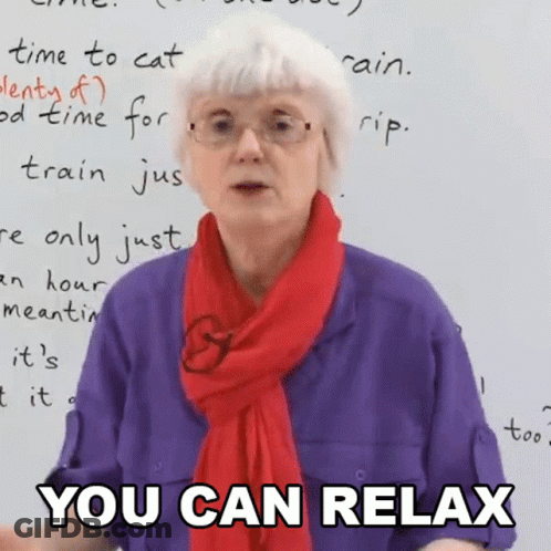 An Elderly Woman Wearing Glasses And A Red Scarf Says " You Can Relax " GIF