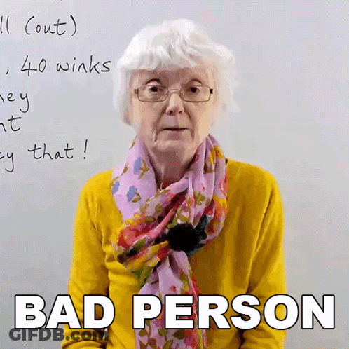 An Elderly Woman Wearing Glasses And A Scarf Says Bad Person In Front Of A Whiteboard GIF