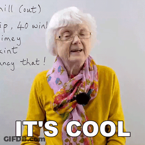 An Elderly Woman Wearing Glasses And A Scarf Says It 'S Cool In Front Of A White Board GIF