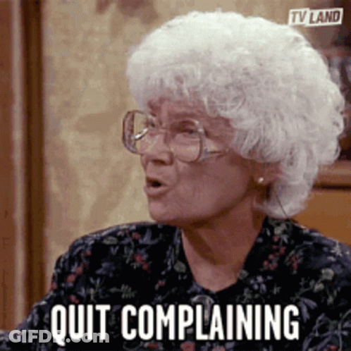 An Elderly Woman Wearing Glasses Says Quit Complaining . GIF