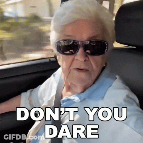 An Elderly Woman Wearing Sunglasses Says " Do N't You Dare " While Driving A Car GIF