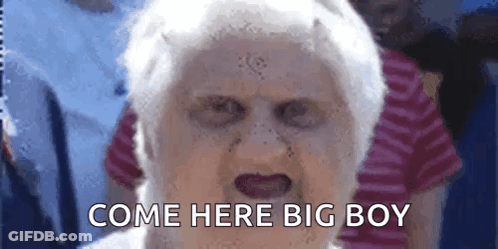 An Elderly Woman With A Scary Face And The Words Come Here Big Boy Written On Her Face . GIF