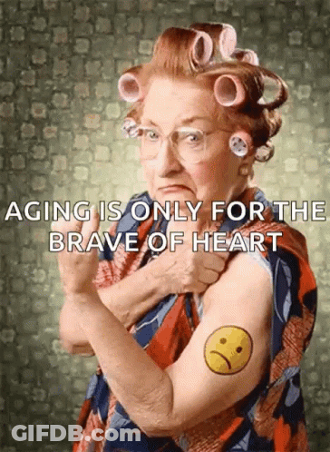 An Elderly Woman With Curlers On Her Hair Has A Tattoo Of An Angry Face On Her Arm GIF