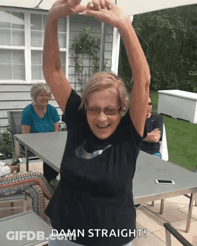 An Elderly Woman With Her Arms In The Air And The Words Damn Straight Below Her GIF
