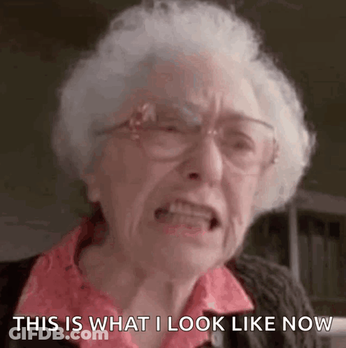 An Elderly Woman With White Hair And Glasses Is Making A Funny Face And Saying `` This Is What I Look Like Now '' . GIF