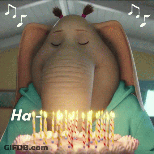 An Elephant Blowing Out Candles On A Birthday Cake That Says Ha GIF