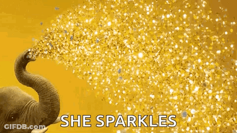 An Elephant Is Blowing Gold Confetti Out Of Its Trunk On A Yellow Background . GIF
