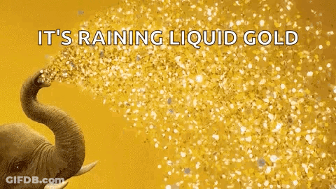 An Elephant Is Spraying Gold Confetti With Its Trunk . GIF
