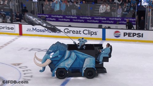 An Elephant Shaped Vehicle Is On The Ice With A Pepsi Ad Behind It GIF