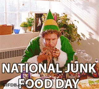 An Elf Is Sitting At A Table Eating Food On National Junk Food Day GIF