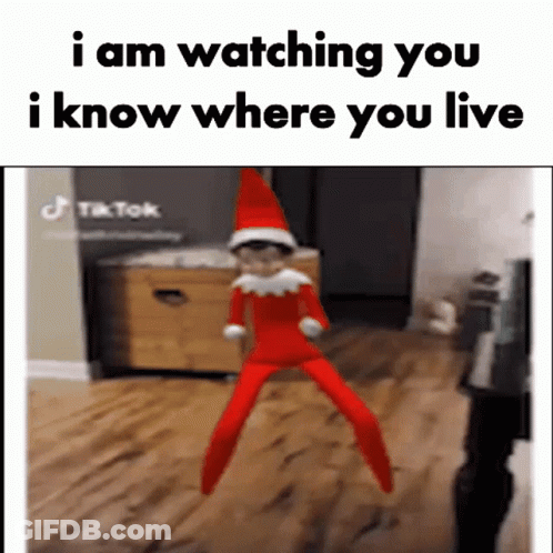 An Elf On The Shelf Is Jumping In The Air And Says `` I Am Watching You I Know Where You Live '' GIF