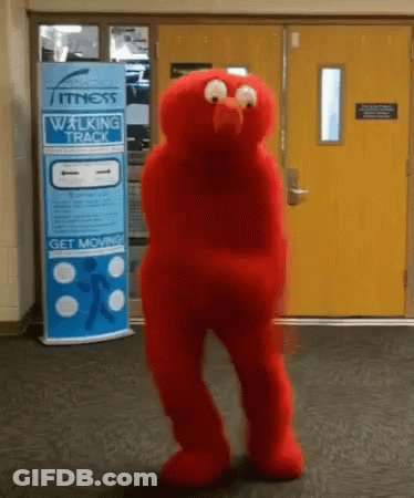 An Elmo Mascot Is Dancing In Front Of A Fitness Walking Track Sign GIF