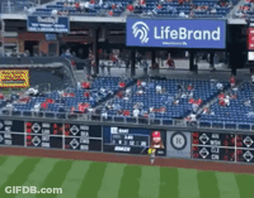 An Empty Baseball Stadium With A Life Brand Sign Above The Stands GIF