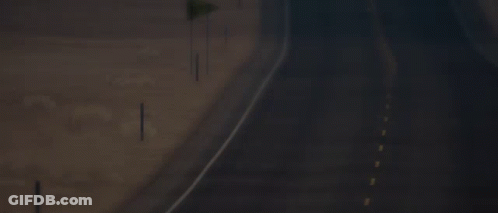 An Empty Highway With A Yellow Flag On The Side GIF