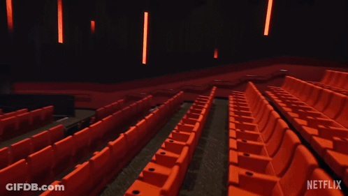 An Empty Movie Theater With A Netflix Logo On The Screen GIF