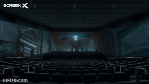 An Empty Movie Theater With A Screen X Logo Behind It GIF