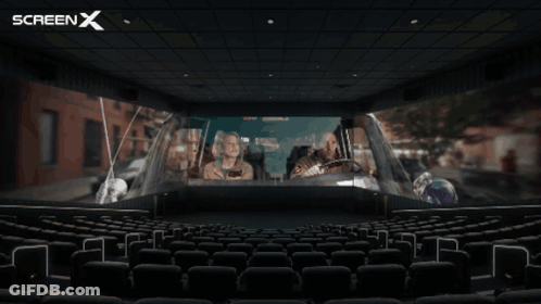 An Empty Movie Theater With A Screen X Logo In The Corner GIF