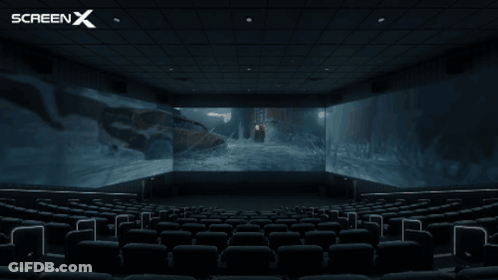 An Empty Movie Theater With A Screen X Logo In The Corner GIF
