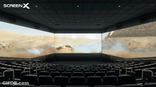 An Empty Movie Theater With A Screen X Logo In The Corner GIF