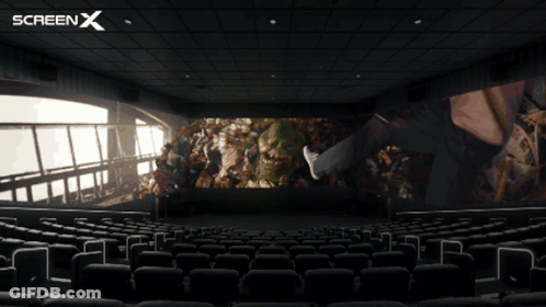 An Empty Movie Theater With A Screen X Logo On The Top GIF