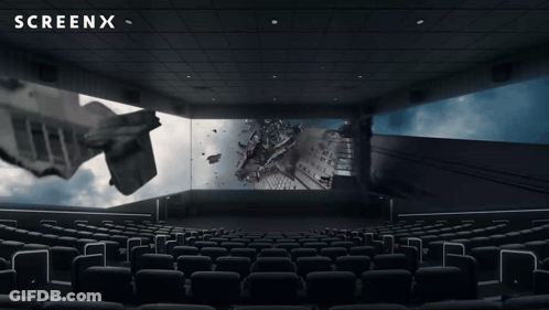 An Empty Movie Theater With A Screenx Logo On The Ceiling GIF