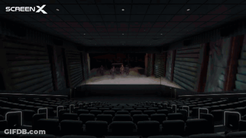 An Empty Movie Theater With The Screen X Logo On The Ceiling GIF