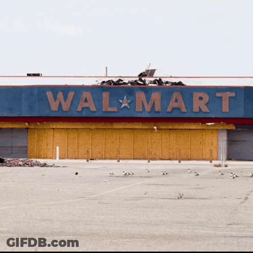 An Empty Parking Lot In Front Of An Empty Walmart GIF