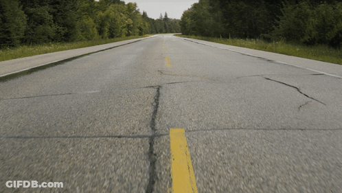 An Empty Road With A Yellow Line On The Side GIF