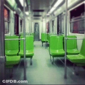 An Empty Subway Car With Green Seats And A Door GIF