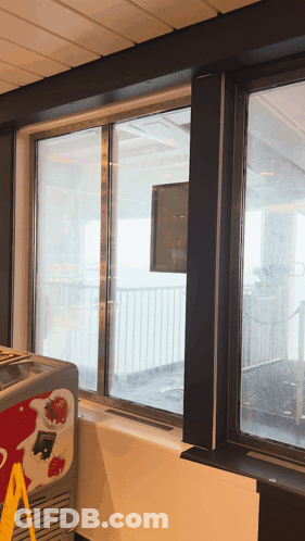 An Ice Cream Cooler With Strawberries On It GIF