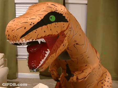 An Inflatable T-Rex With A Green Eye Is Standing In A Living Room GIF