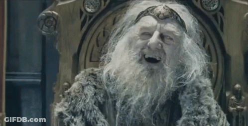 An Old Man With A Beard And A Crown Is Sitting On A Throne And Smiling . GIF