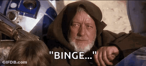 An Old Man With A Beard Is Sitting Next To A Robot And Says " Binge " GIF