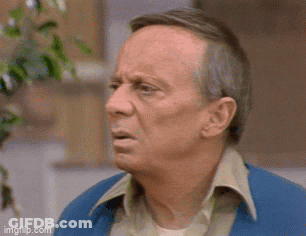 An Older Man In A Blue Jacket Is Making A Funny Face . GIF