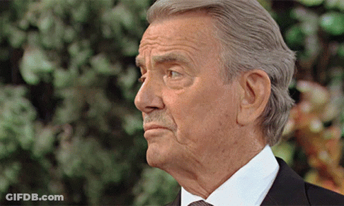 An Older Man In A Suit And Tie Is Looking To The Side GIF