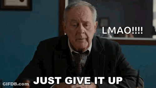 An Older Man In A Suit And Tie Is Sitting At A Desk And Says Lmao Just Give It Up GIF
