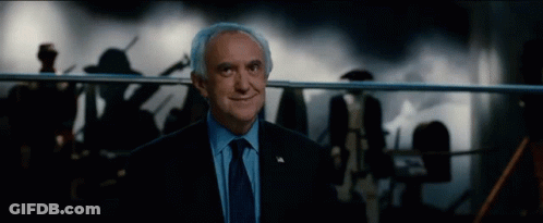 An Older Man In A Suit And Tie Is Smiling GIF