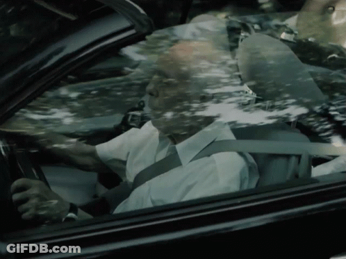 An Older Man Is Driving A Car With A Seat Belt On GIF