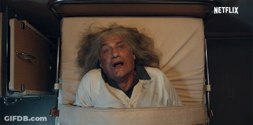 An Older Man Is Laying In A Hospital Bed With A Netflix Logo Behind Him GIF