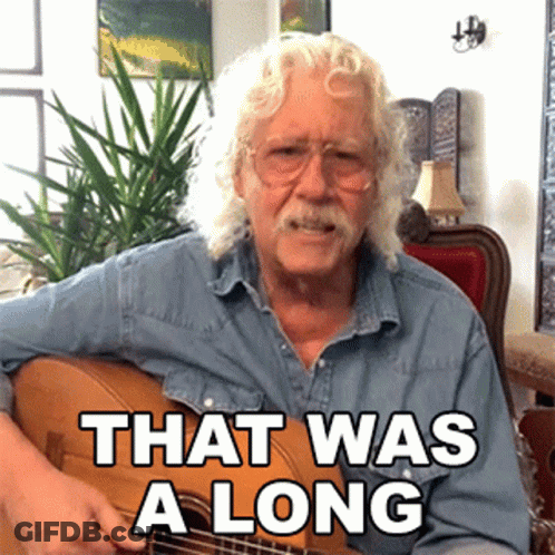 An Older Man Playing A Guitar With The Words That Was A Long Below Him GIF