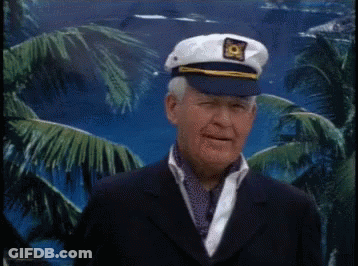 An Older Man Wearing A Captain 'S Hat And A Suit GIF