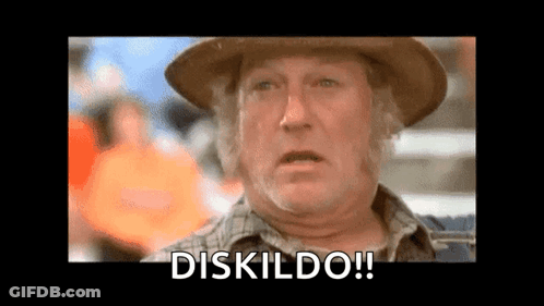 An Older Man Wearing A Cowboy Hat And A Plaid Shirt Is Making A Funny Face And Saying Diskildo . GIF