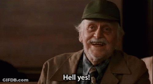 An Older Man Wearing A Hat And Tie Is Smiling And Saying Hell Yes . GIF