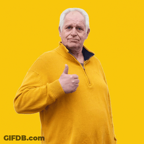 An Older Man Wearing A Yellow Sweater Gives A Thumbs Up GIF