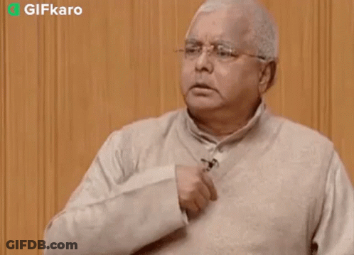 An Older Man Wearing Glasses And A Sweater Is Giving A Thumbs Up Sign . GIF