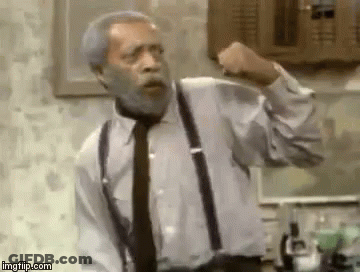 An Older Man With A Beard And Suspenders Is Making A Fist . GIF