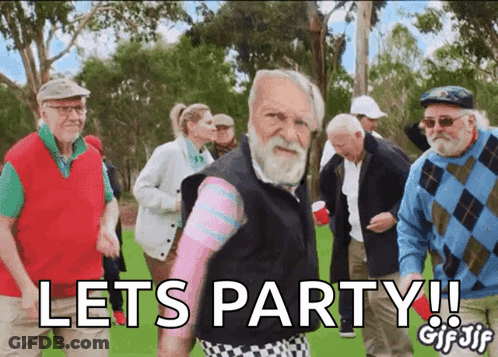 An Older Man With A Beard Stands In Front Of A Group Of Older People And Says Lets Party GIF