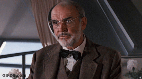 An Older Man With Glasses And A Bow Tie GIF